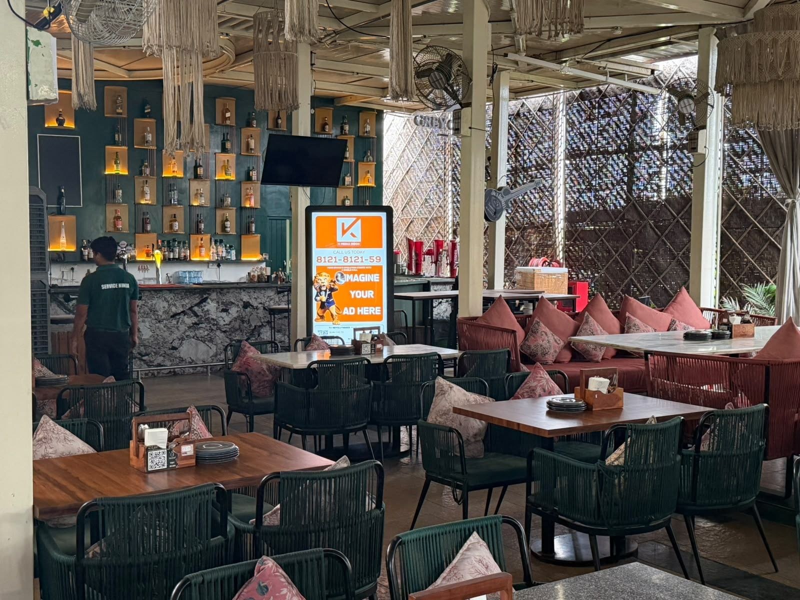 KMEDIA digital advertising screen at a premium lounge venue